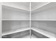 Bright walk-in closet with white shelving for ample storage, ready for organization and easy access to your wardrobe at 18371 W Roma Ave, Goodyear, AZ 85395