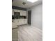 Renovated kitchen area with updated counters, white cabinets, black backsplash, and bright lighting at 2019 E Southern Ave, Phoenix, AZ 85040