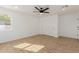 Bedroom featuring sleek ceiling fan, wood flooring, and a closet with sliding doors at 2041 W Palo Verde Dr, Phoenix, AZ 85015