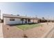Charming home featuring a white exterior, dark trim, manicured lawn, and a spacious driveway with a convenient covered parking area at 2041 W Palo Verde Dr, Phoenix, AZ 85015