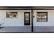 Charming front entrance with a modern black door, complemented by freshly painted stucco and symmetrical window placements at 2041 W Palo Verde Dr, Phoenix, AZ 85015