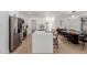Open concept kitchen with stainless steel appliances, white cabinets, and island seating at 2041 W Palo Verde Dr, Phoenix, AZ 85015