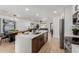 Modern kitchen with stainless steel appliances, white countertops, and a view into the living room at 2041 W Palo Verde Dr, Phoenix, AZ 85015