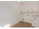Bright laundry room with tiled floor and white cabinets above washer/dryer hookups at 2041 W Palo Verde Dr, Phoenix, AZ 85015
