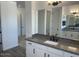 Bathroom vanity with granite countertops, double sinks, white cabinets, and modern fixtures at 231Xx W Gloria Ln, Wittmann, AZ 85361