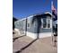 Well-maintained mobile home with blue siding, white trim, and mature landscaping at 2600 E Allred Ave # R-88, Mesa, AZ 85204