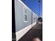 Comfortable mobile home showcasing blue siding and lush landscaping in a tranquil setting at 2600 E Allred Ave # R-88, Mesa, AZ 85204