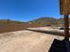 This is the backyard of a new home build with a brick wall and view of the desert mountains at 27366 N 69Th Dr, Peoria, AZ 85383