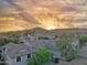 Scenic aerial view of a residential neighborhood, showing rooftops, lush greenery, and distant mountain backdrop at 2947 N Evergreen St, Buckeye, AZ 85396