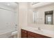 Full bathroom features a tub and shower combo, wood vanity, and a large mirror at 2947 N Evergreen St, Buckeye, AZ 85396