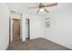 Bright bedroom features a ceiling fan, neutral carpet, and closet with sliding doors at 2947 N Evergreen St, Buckeye, AZ 85396