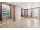 Bright and airy living room with tile flooring, multiple windows, and access to outdoor space at 2947 N Evergreen St, Buckeye, AZ 85396