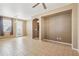 Spacious living area featuring tile flooring, arched doorways, and access to the kitchen at 2947 N Evergreen St, Buckeye, AZ 85396