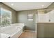 The main bathroom features a large tub, a window, and a separate glass-enclosed shower at 2947 N Evergreen St, Buckeye, AZ 85396