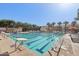 Community pool with lap lanes, lounge chairs, and palm trees at 2947 N Evergreen St, Buckeye, AZ 85396