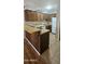 Efficient kitchen featuring wood cabinets, laminate countertops, and hanging pot rack at 3131 W Cochise Dr # 256, Phoenix, AZ 85051