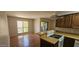 Efficient kitchen with appliances, breakfast bar, and sliding doors to the patio at 3131 W Cochise Dr # 256, Phoenix, AZ 85051