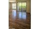 Living room featuring wood-style floors, sliding glass door, and sunlit interior at 3131 W Cochise Dr # 256, Phoenix, AZ 85051