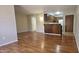 Open-concept living room and kitchen with wood-style floors and breakfast bar at 3131 W Cochise Dr # 256, Phoenix, AZ 85051