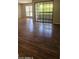 Living room featuring wood-style floors, sliding glass door, and sunlit interior at 3131 W Cochise Dr # 256, Phoenix, AZ 85051