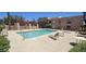 Inviting community swimming pool with deck chairs, set against a backdrop of modern apartment buildings on a sunny day at 3131 W Cochise Dr # 256, Phoenix, AZ 85051