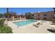 Community swimming pool surrounded by lounge chairs, palm trees, and well-maintained modern apartment buildings at 3131 W Cochise Dr # 256, Phoenix, AZ 85051