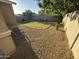 This backyard features grass, gravel, and a playset at 330 W Evergreen Pear Ave, Queen Creek, AZ 85140