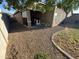 This backyard features a covered patio, playset, and gravel at 330 W Evergreen Pear Ave, Queen Creek, AZ 85140