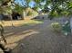 This backyard features mature landscaping and rocks at 330 W Evergreen Pear Ave, Queen Creek, AZ 85140