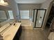 This bathroom features double sinks, a glass enclosed shower, and lots of natural light at 330 W Evergreen Pear Ave, Queen Creek, AZ 85140