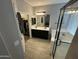 This bathroom features double sinks, a glass enclosed shower, and wood look tile at 330 W Evergreen Pear Ave, Queen Creek, AZ 85140
