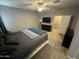 This bedroom features wood flooring, a ceiling fan, and neutral walls at 330 W Evergreen Pear Ave, Queen Creek, AZ 85140