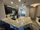 Modern kitchen with granite countertops, stainless steel appliances, and dark cabinets at 330 W Evergreen Pear Ave, Queen Creek, AZ 85140