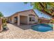 Inviting backyard featuring a refreshing pool and a covered patio for outdoor enjoyment at 33207 N Slate Creek Dr, San Tan Valley, AZ 85143
