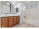Bathroom featuring double sinks, sleek fixtures, and a shower-tub combination at 33207 N Slate Creek Dr, San Tan Valley, AZ 85143