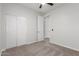 Clean bedroom featuring plush carpet, closet, and a ceiling fan at 33207 N Slate Creek Dr, San Tan Valley, AZ 85143