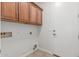 Functional laundry room featuring ample cabinet space and essential utility connections at 33207 N Slate Creek Dr, San Tan Valley, AZ 85143