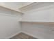 A walk-in closet featuring built-in wooden shelving on all sides for ample storage at 33207 N Slate Creek Dr, San Tan Valley, AZ 85143