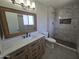 Modern bathroom with tiled walk-in shower, stylish vanity, and a framed mirror at 3810 W Yucca St, Phoenix, AZ 85029