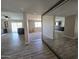 Open-concept living room showcasing wood-look flooring and a view into the kitchen with modern bar seating at 3810 W Yucca St, Phoenix, AZ 85029