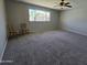 Spacious living room featuring carpet flooring, neutral paint, and view of the neighborhood at 3810 W Yucca St, Phoenix, AZ 85029