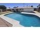 Backyard pool with a concrete deck and lush green landscaping. Provides the perfect outdoor retreat at 3810 W Yucca St, Phoenix, AZ 85029