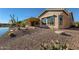 Backyard of a home featuring a covered patio and lake views at 42625 W Sandpiper Dr, Maricopa, AZ 85138