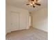 Empty bedroom with a ceiling fan and a sliding door closet at 42625 W Sandpiper Dr, Maricopa, AZ 85138
