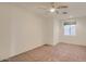 Empty bedroom with a ceiling fan and a window with blinds at 42625 W Sandpiper Dr, Maricopa, AZ 85138