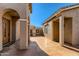 Exterior front walkway showcases two welcoming doorways and outdoor decor at 42625 W Sandpiper Dr, Maricopa, AZ 85138