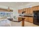Bright kitchen with granite countertops, modern appliances, and tile flooring at 42625 W Sandpiper Dr, Maricopa, AZ 85138