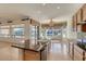 Kitchen boasting granite countertops, an island, and large windows, perfect for meal prep with a view at 42625 W Sandpiper Dr, Maricopa, AZ 85138