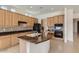 Modern kitchen with granite countertops, center island, and black appliances, perfect for cooking and entertaining at 42625 W Sandpiper Dr, Maricopa, AZ 85138