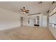 Spacious living room with a ceiling fan and a decorative built-in media center at 42625 W Sandpiper Dr, Maricopa, AZ 85138